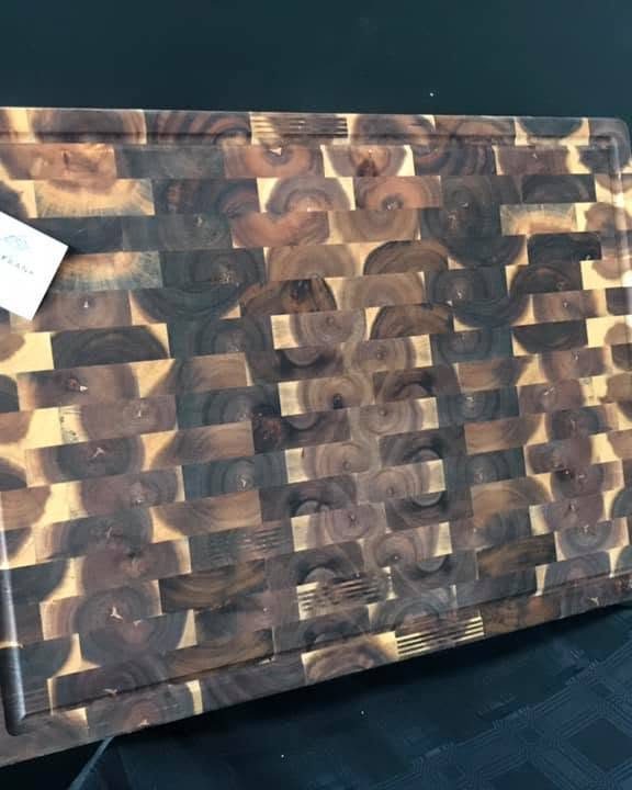A dark end-grain chopping board showing the chequered ends of the timber fibres