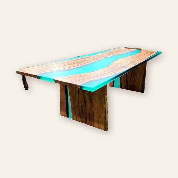 River table with a turquoise resin channel and timber waterfall legs