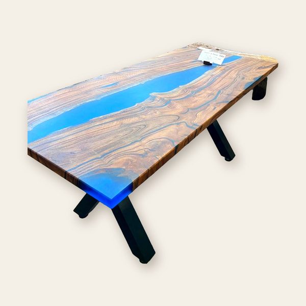 River table with a blue resin channel on black steel X-legs