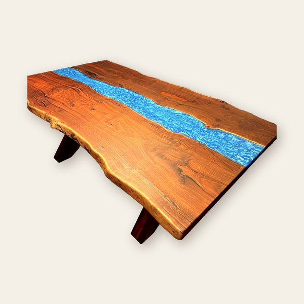 Red-brown river table with a sparkling blue resin channel
