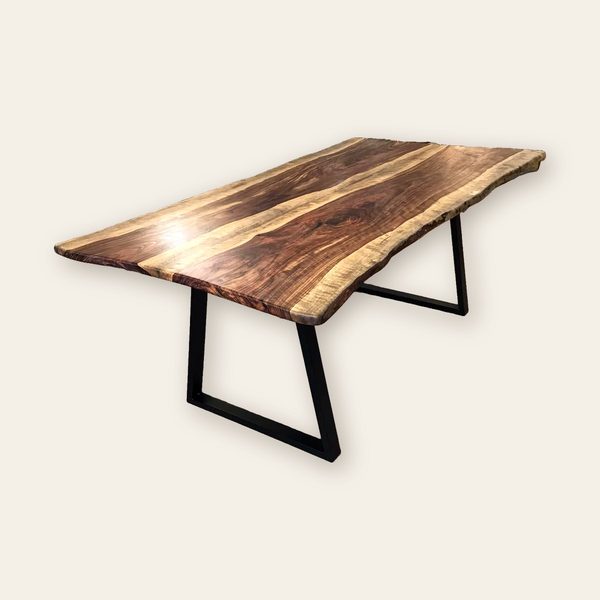 Dark live-edge dining table on black steel trapezoid legs