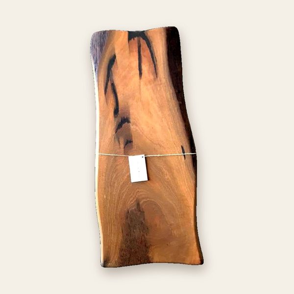 Long natural-edge board with dark streaks through the grain
