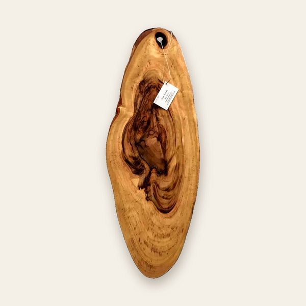 Long oval board with swirling figure and a hanging hole