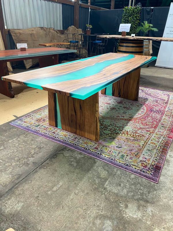 Close view of turquoise river table with timber waterfall legs