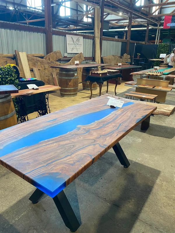 Blue resin river table on black X-legs