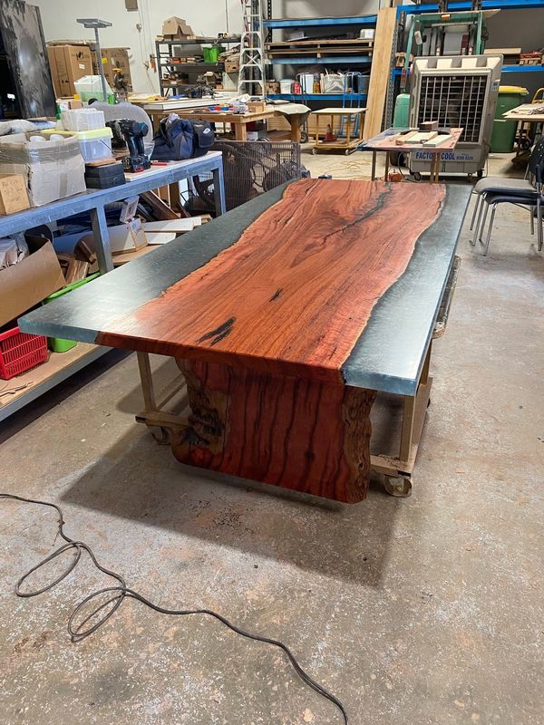 Jarrah slab with grey resin river in the workshop