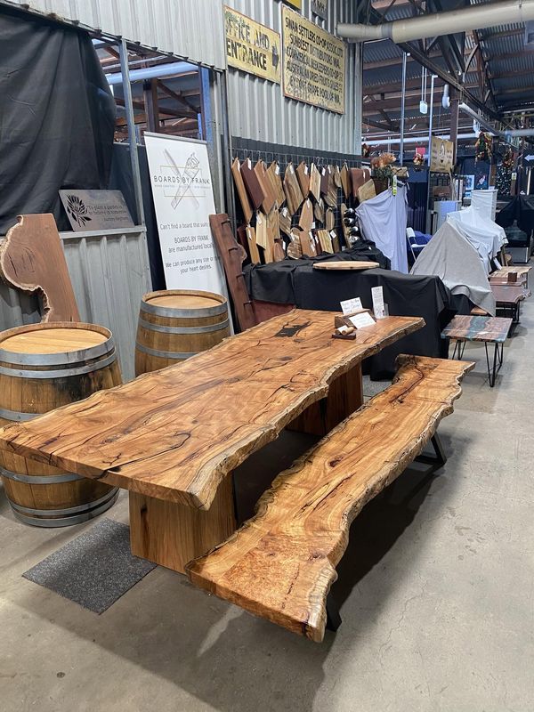 Live-edge dining table and bench set at stall