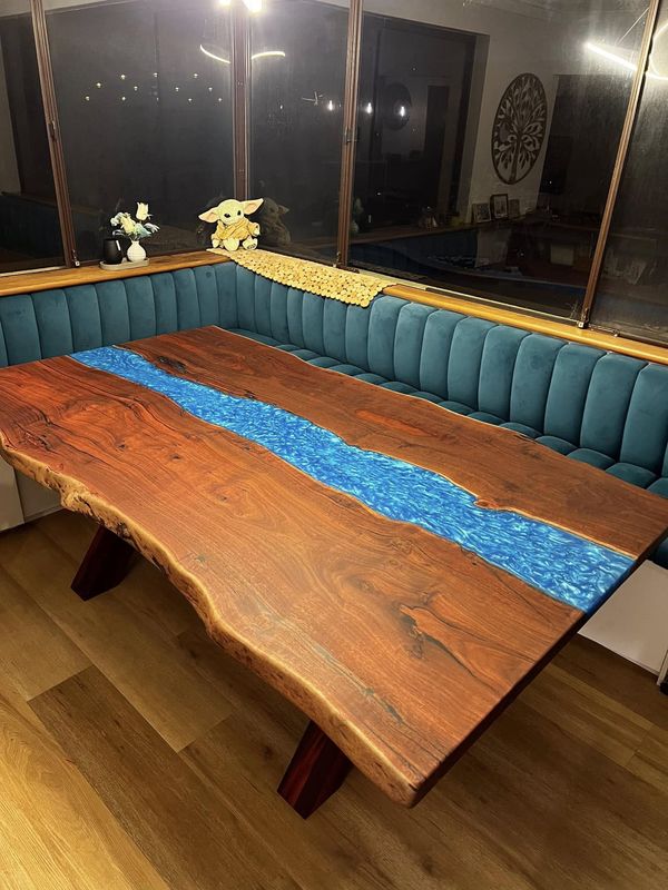 River table installed in a dining nook with teal banquette