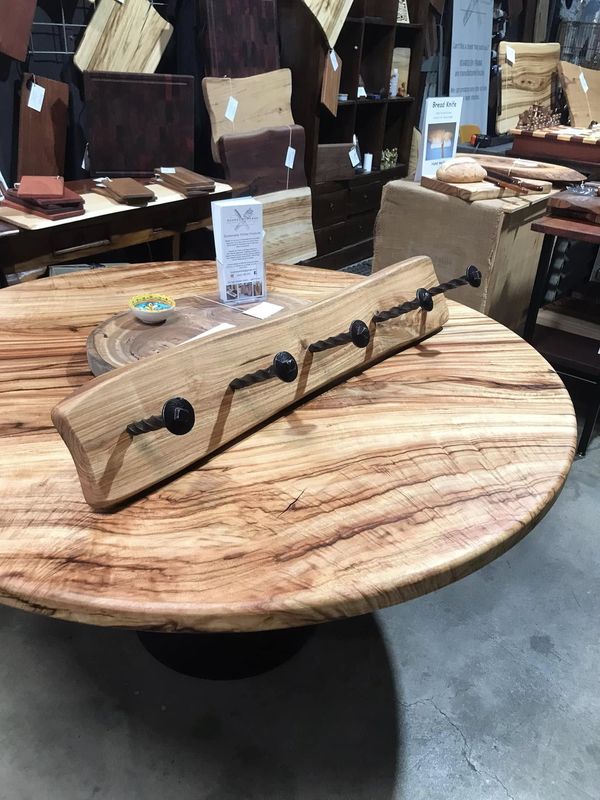 Blonde coat-hook board on round slab table