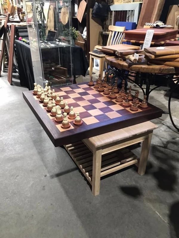 Chess table with a raised board and pieces, seen from the side