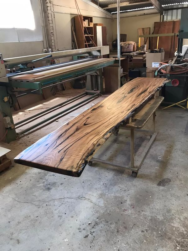 Raw marri slab on trestles in workshop